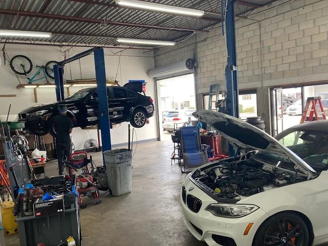 Shop floor with vehicles on lifts at Ose Automotive Performance